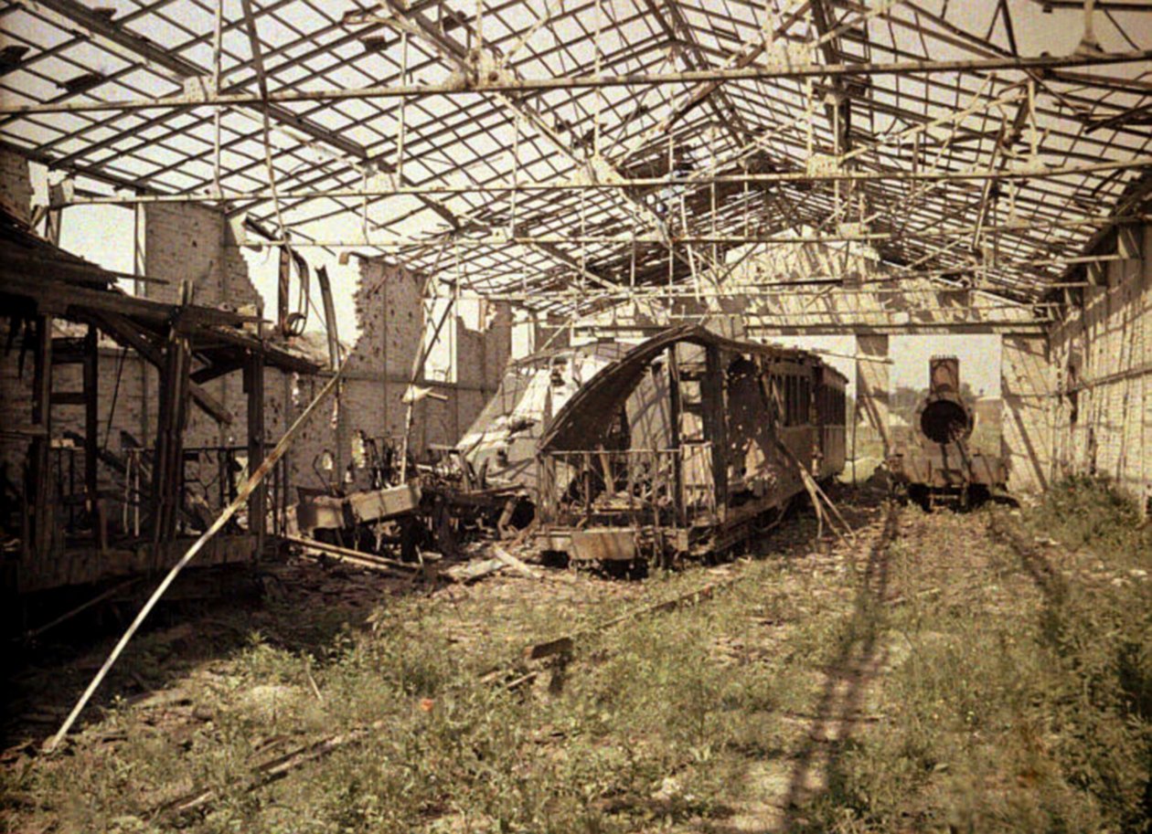 Den udbrændte jernbane- og sporvognsgård med et par beskadigede køretøjer og et lokomotiv, Soissons, Aisne, Frankrig, 1917 (autokrom) af Fernand Cuville