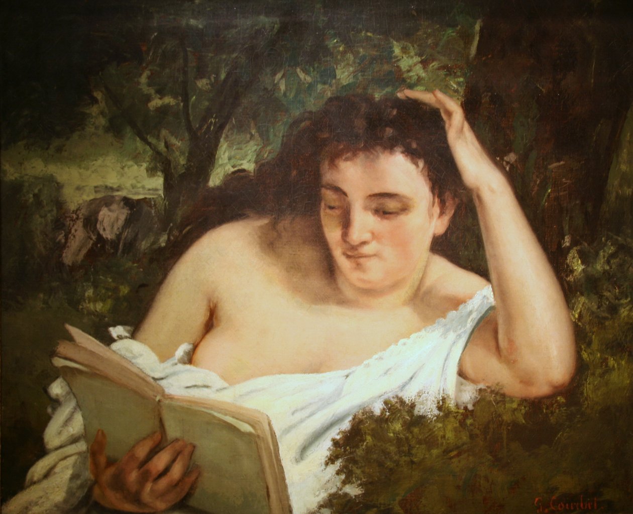 En ung kvinde læser af Gustave Courbet