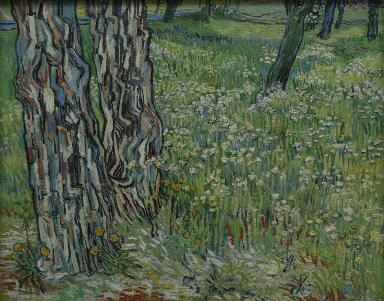 Træstammer i græsset af Vincent van Gogh